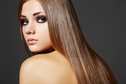 Health, beauty, wellness, haircare, cosmetics and make-up. Beautiful fashion hairstyle. Woman model with shiny straight long hair and evening make-up.