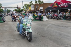 Sturgis, South Dakota - August 8, 2014: Rider in the main street of the city of Sturgis, in South Dakota, USA, during the annual Sturgis Motorcycle Rally