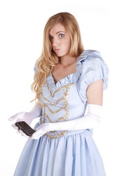 A woman dressed like Cinderella is holding a cell phone wondering what to do with it.