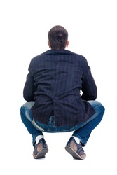 Sitting young man looking afar. Rear view. Isolated over white.
