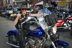 Sturgis, South Dakota - August 9, 2014: Rider in the main street of the city of Sturgis, in South Dakota, USA, during the annual Sturgis Motorcycle Rally