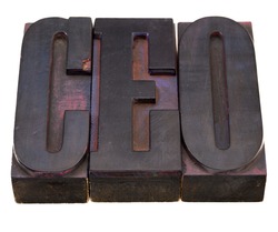 chief executive officer (CEO) acronym in antique wood letterpress printing blocks, stained by color inks, isolated on white
