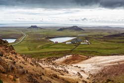 View of small lakes on a background of mountains under cloudy sky in Iceland.