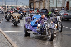 A man on a blue three-wheeled motorcycle rides along Dvortsovaya Embankment on August 5, 2017 in St. Petersburg, Russia