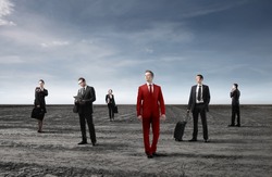 Group of business people in black and businessman in red