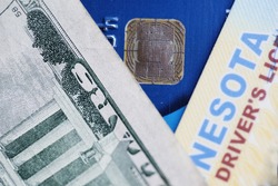 Important items in today's world, including dollar bill, credit card and drivers license.