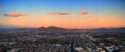 Las Vegas City Skyline panorama with sunset, mountain, luxury hotels and streets.
