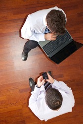 Top view of two business men using laptop and phone mobile and having conversat