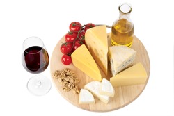 Four popular kinds of cheese, tomatoes and red wine glass on a white background. A shot horizontal, focus in the shot foreground.