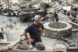 GLEN ELLEN, CALIFORNIA/ USA - OCT 16, 2017: A man stands in the ruins of his burned home in Glen Ellen. Fires in California have burned over 220,000 acres and destroyed 5700 structures.
