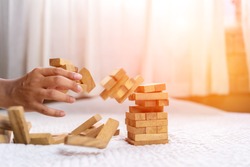Hand of pulling wood block fail on building tower at home and drape change, choice business risking dangerous project plan failure construction,Selective block wooden