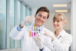science and research biology chemistry an dmedicine youn people couple in bright modern lab