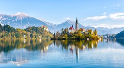 Lake Bled Slovenia. Beautiful mountain lake with small Pilgrimage Church. Most famous Slovenian lake and island Bled with Pilgrimage Church of the Assumption of Maria and Bled Castle in background.