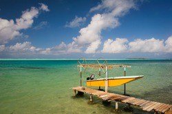 Yellow boat and turquoise water of Pacific, Maupiti, French Polynesia, Society Islands