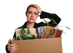 Upset businesswoman carrying office belongings after loosing job