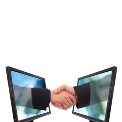 Businessmen shake hands from two lcd monitors isolated on white