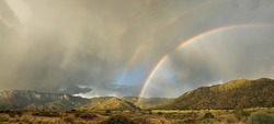A rare double rainbow appears over Albuquerque's Sandia Mountains in the monsoon season