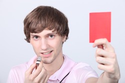 Teenager holding up a red card