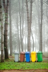 Recycling bin in park for protect environment.Colour of trash contains different type of garbage.Make it easy for waste control. Recycling way save the world for non polluting,environmentally-friendly
