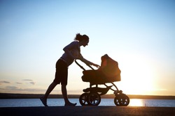 Silhouette of young mother enjoying motherhood