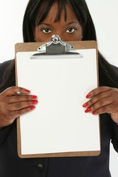 Add text. Beautiful 29 year old African American business woman holding clipboard with blank page towards camera.