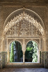 A view to the courtyard through arched windows. Alhambra Palace, Granada, Andalucia, Spain.