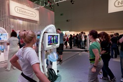 COLOGNE - AUGUST 20: Female Videogamers playing with Nintendo Wii and Just Dance 3 at GamesCom 2011, the most important European video games Expo August 20, 2011 in Cologne, DE