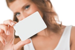 Woman hand holding white empty blank business card, shallow DOF, face in blur