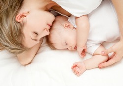 Young mother and her baby, sleeping in bed