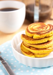 Gluten Free Coconut Flour Pancakes Served for Breakfast with Black Coffee and Maple Syrup