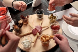 Business lunch - Group of people eating lunch of a set of delicious spicy snacks