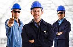 Three engineers at work in a construction site