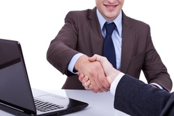 Conclusion of job interview - two young men shaking hands