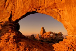 Turret Arch through the North Window at sunrise in Arches National Park near Moab, Utah