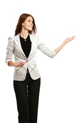 A full-length portrait of a businesswoman displaying with her arm, isolated on white background
