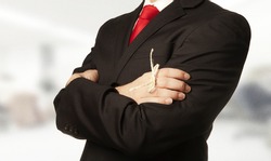 man in business suit with a knot around his finger to make him remember something!