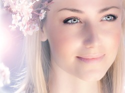 Sensual portrait of a spring woman, beautiful face female enjoying cherry blossom, dreamy girl with pink fresh flowers outdoor, seasonal nature, tree branch and glamorous lady