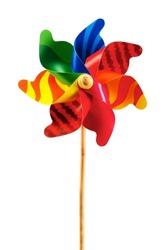 Bright rainbow-colored toy pinwheel with natural wood handle, vertical layout and isolated on white background with space for copy.