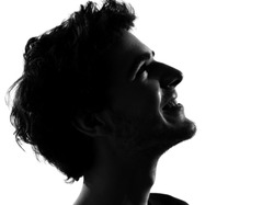 young man looking up portrait silhouette in studio isolated on white background