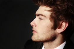 low key image of side profile of a young man