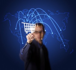 businessman pressing cart button on world map - symbol of modern online marketing and shopping
