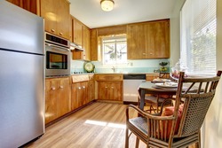 Cute old updated kitchen with blue tiles and new hardwood floor.