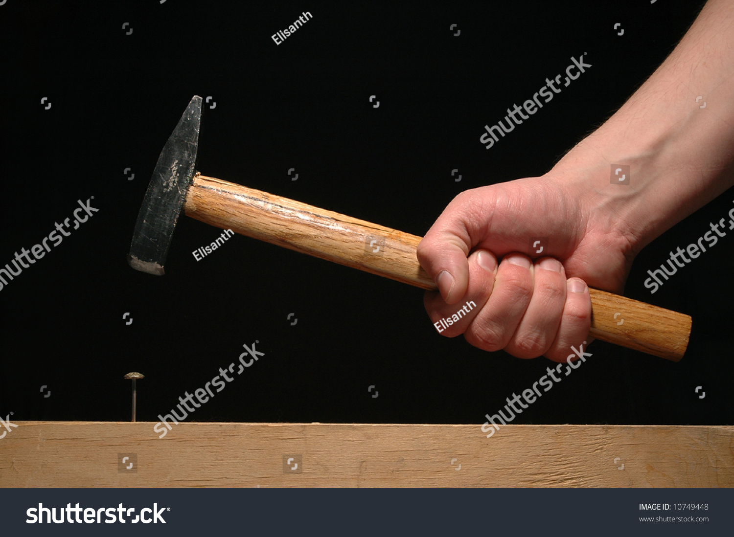 Hand Holding Hammer Isolated On Black Stock Photo 10749448 Shutterstock