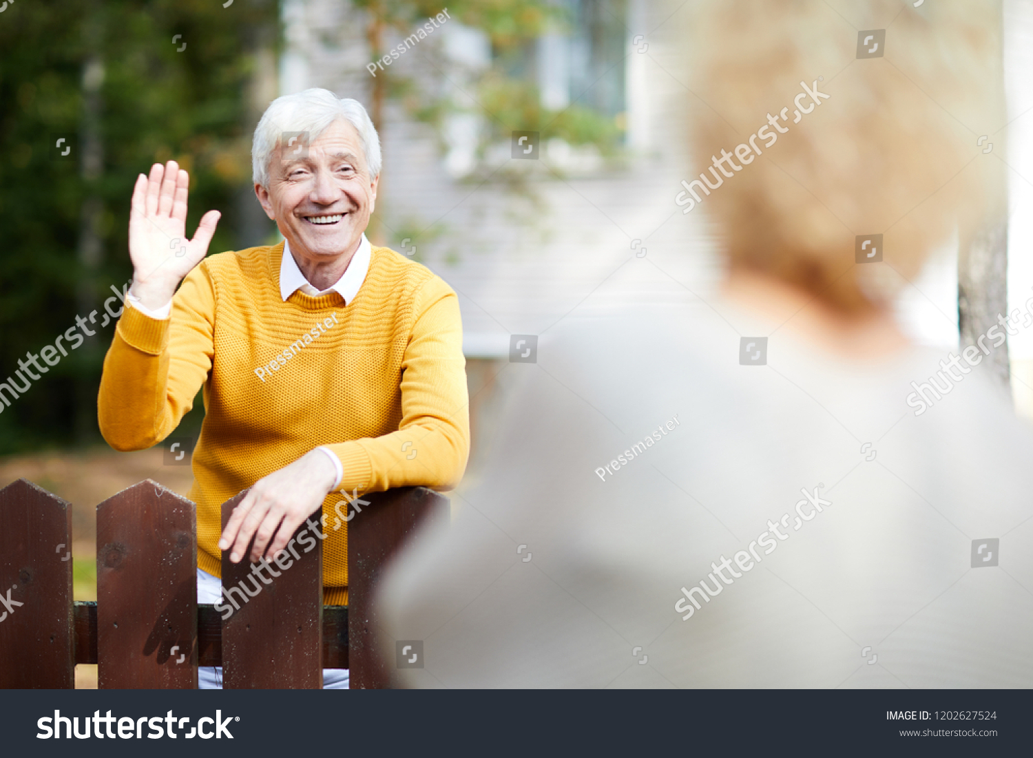 Cheerful Friendly Mature Man Waving Hand Stock Photo