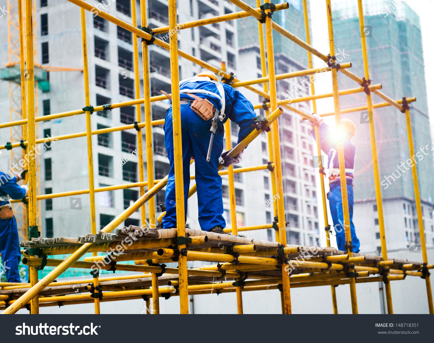 Construction Workers Working On Scaffolding Stock Photo