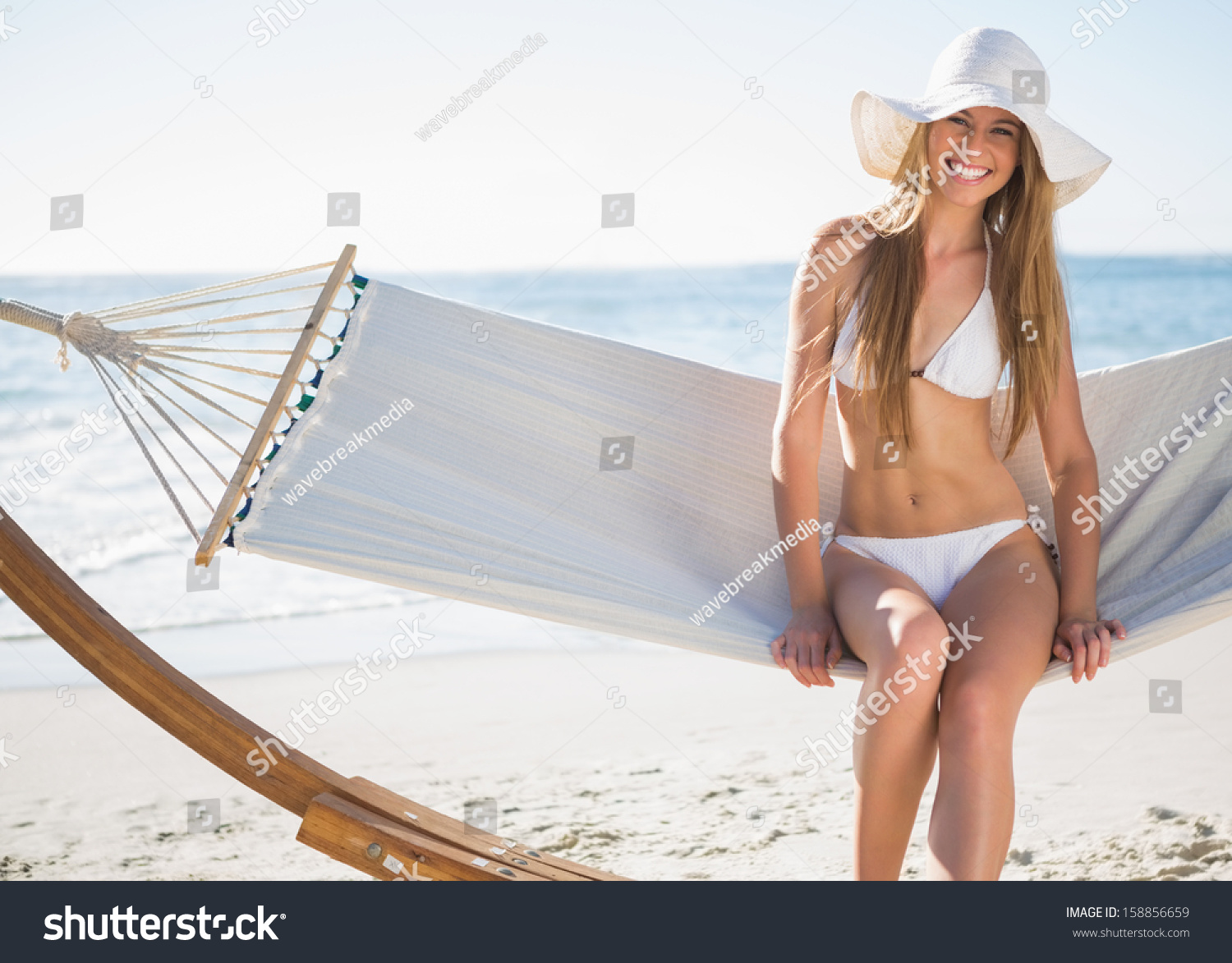 Pretty Blonde Wearing Bikini Sunhat Sitting Stock Photo