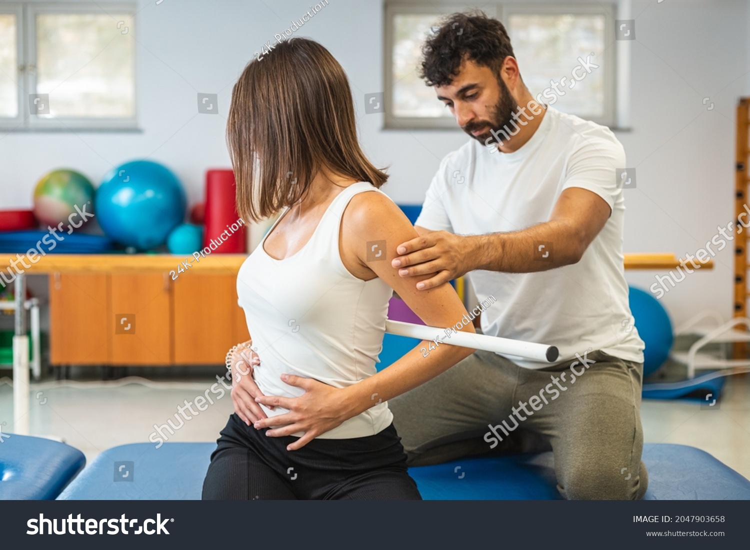 Woman During Rehab Treatment Male Physiotherapist Stock Photo