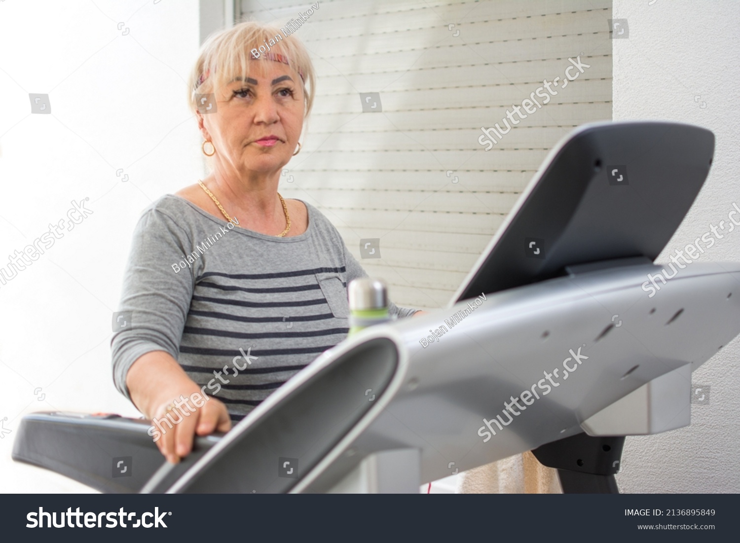 Sporty Mature Woman Using Indoors Treadmill Stock Photo 2136895849