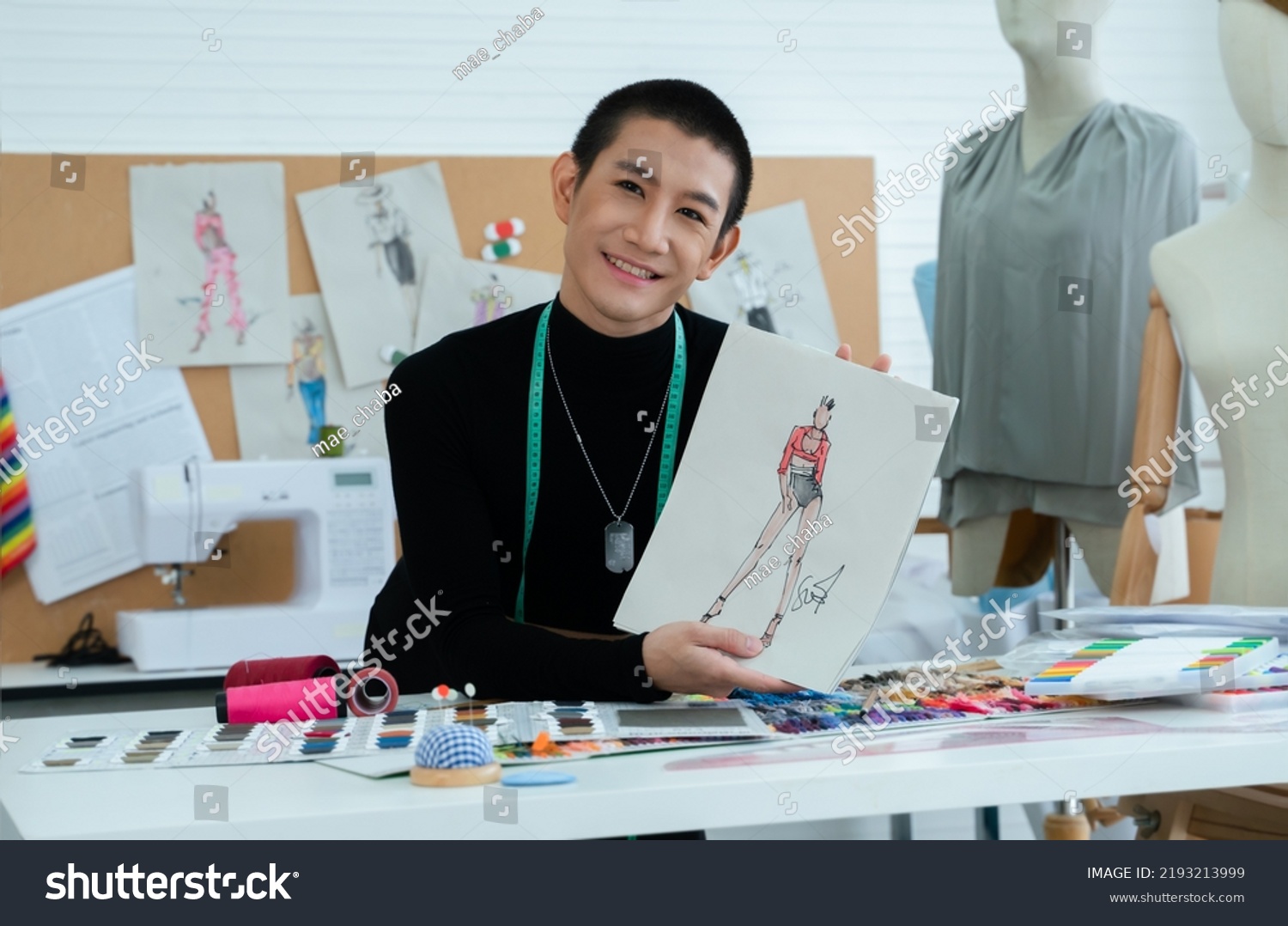 Asian Lgbtq Gay Dressmaker Showing Sketch Stock Photo