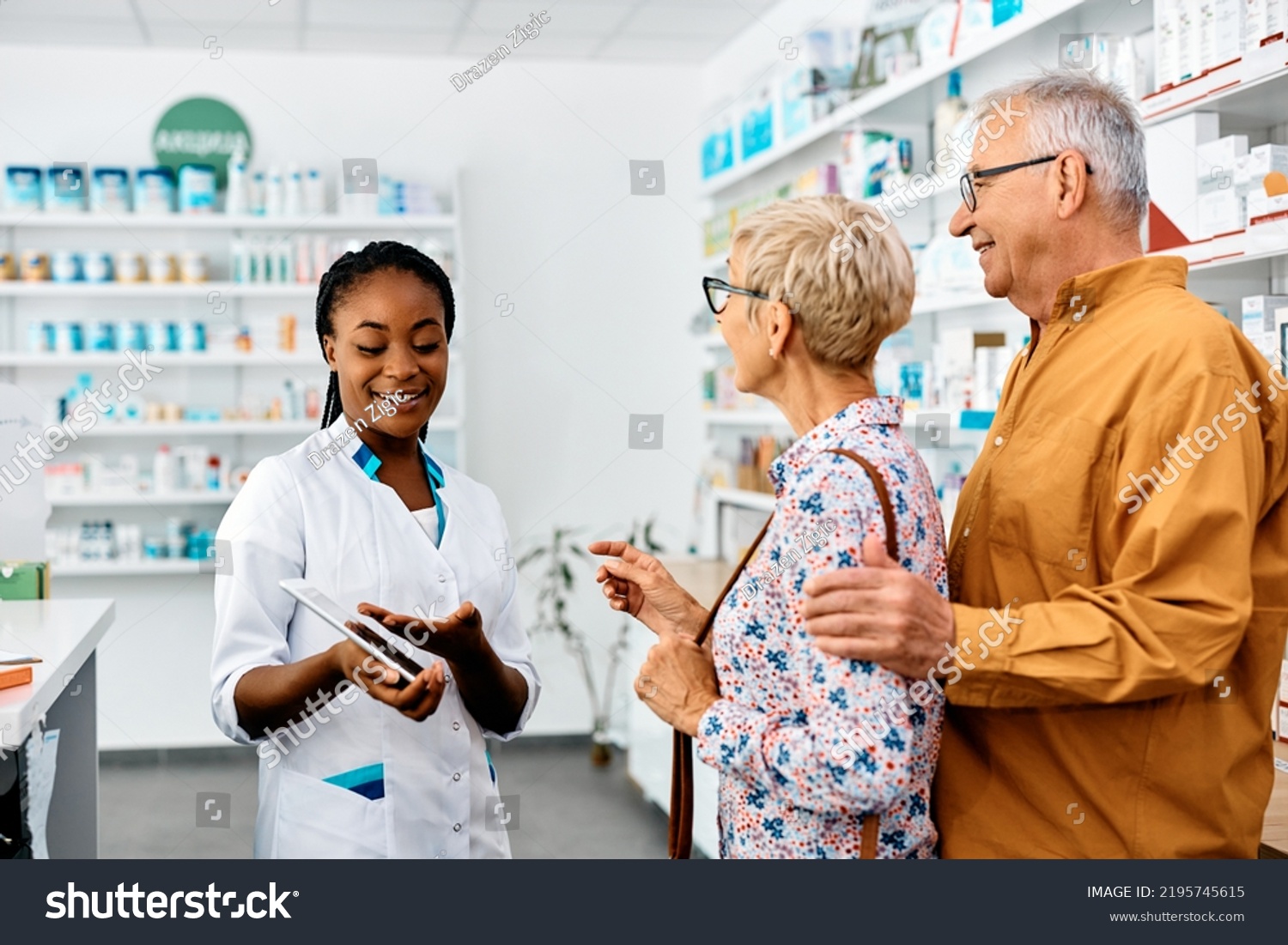 Happy African American Female Pharmacist Talking Stock Photo